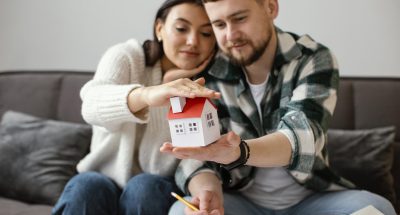 couple-holding-small-house-medium-shot couple-holding-small-house-medium-shot